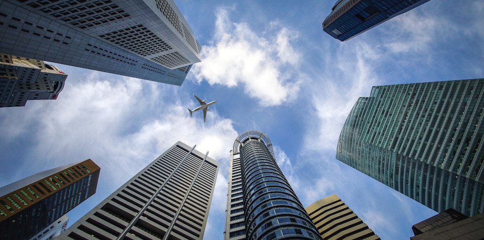 Plane flying over city